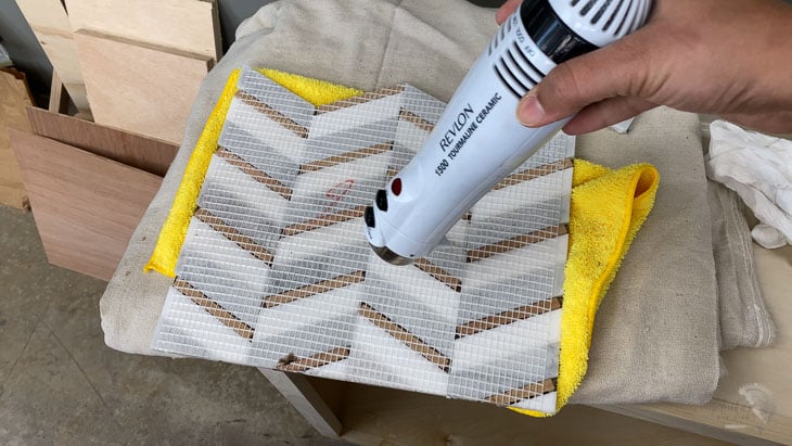 drying the mosaic tile using a hair dryer