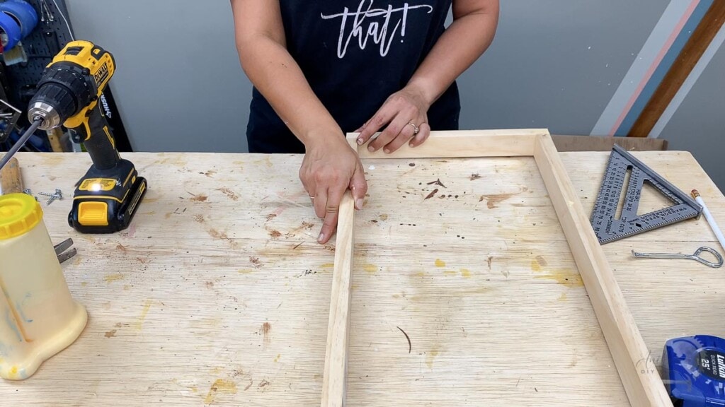 woman building the frame for the cane webbing