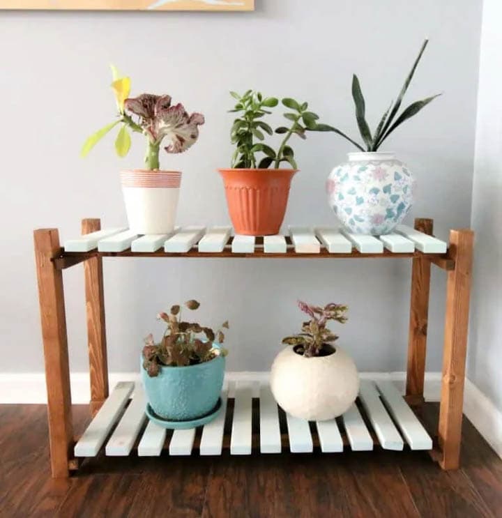 two shelf slated plant stand with plants
