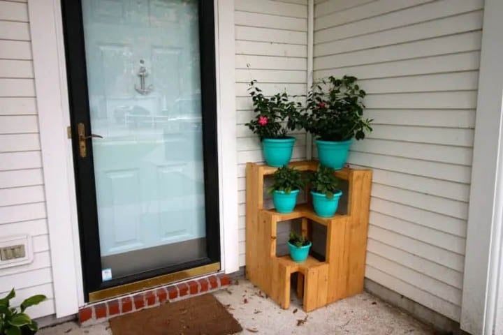 3 tiered plant stand with teal pots with plants in them