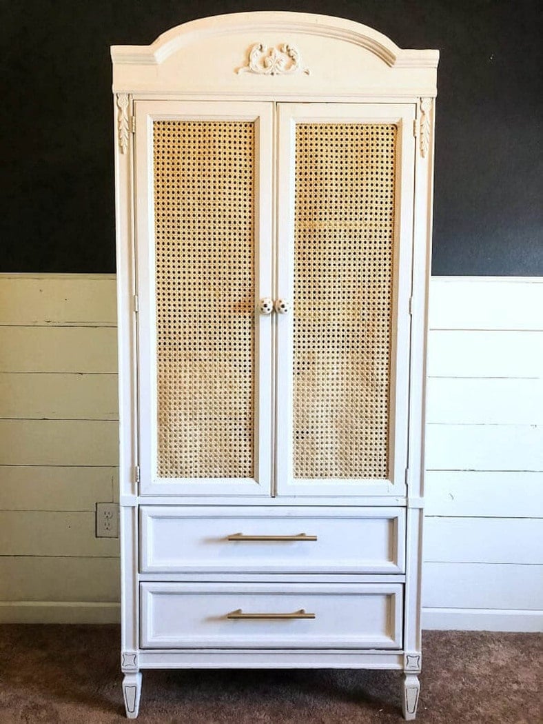 armoire painted white with cane webbing on the door panels.