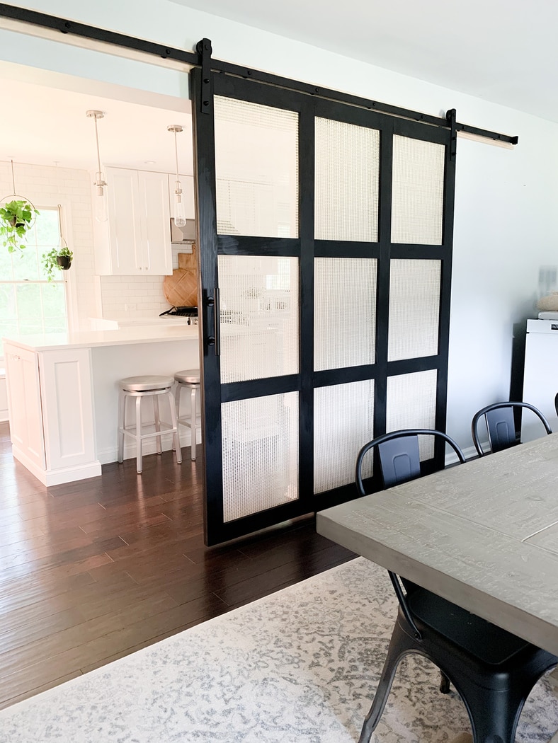 sliding door with cane webbing panels between the dining room and kitchen