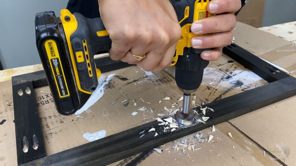 woman using forstener bit to make holes in the board