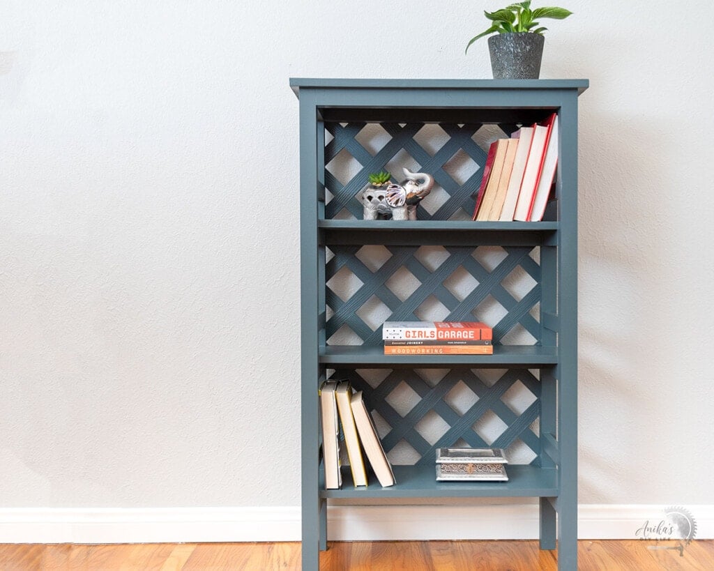 bookshelf built with trellis back with books and plants