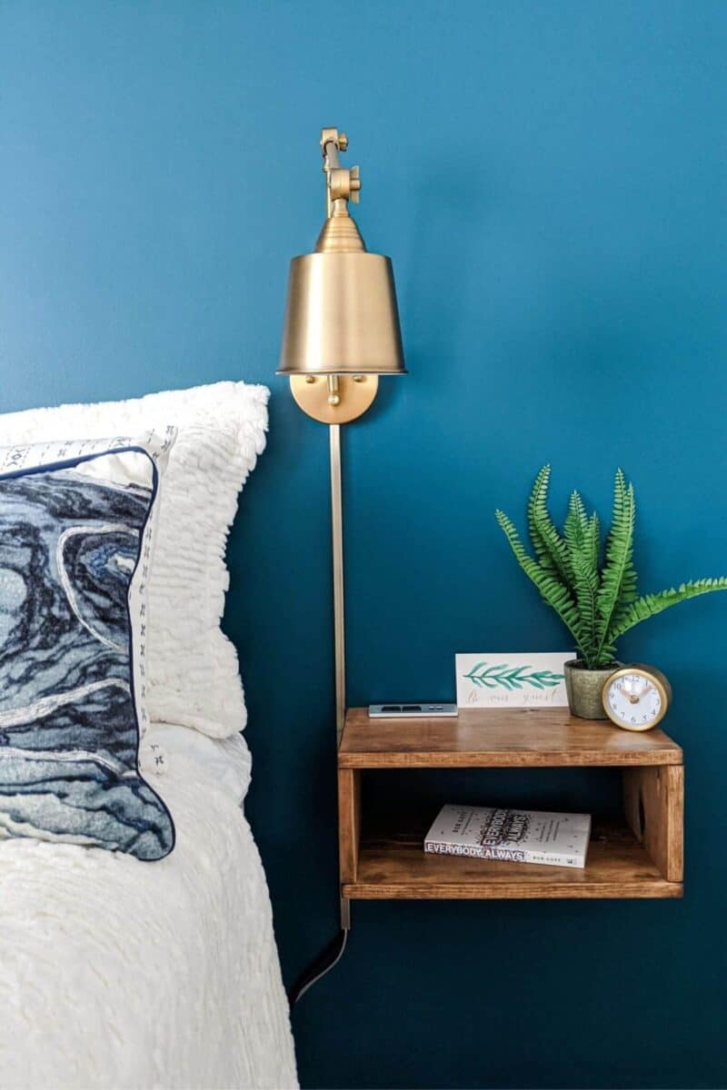 floating DIY nightstand with sconce above it