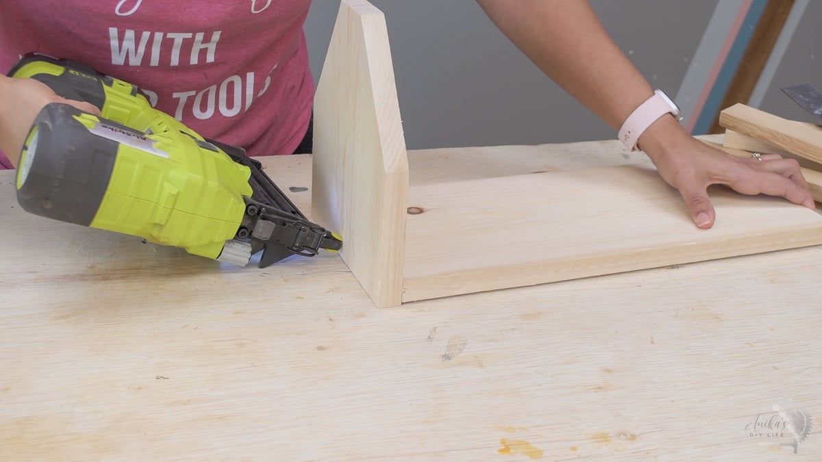 woman assembling the DIY tool box by attaching one end.