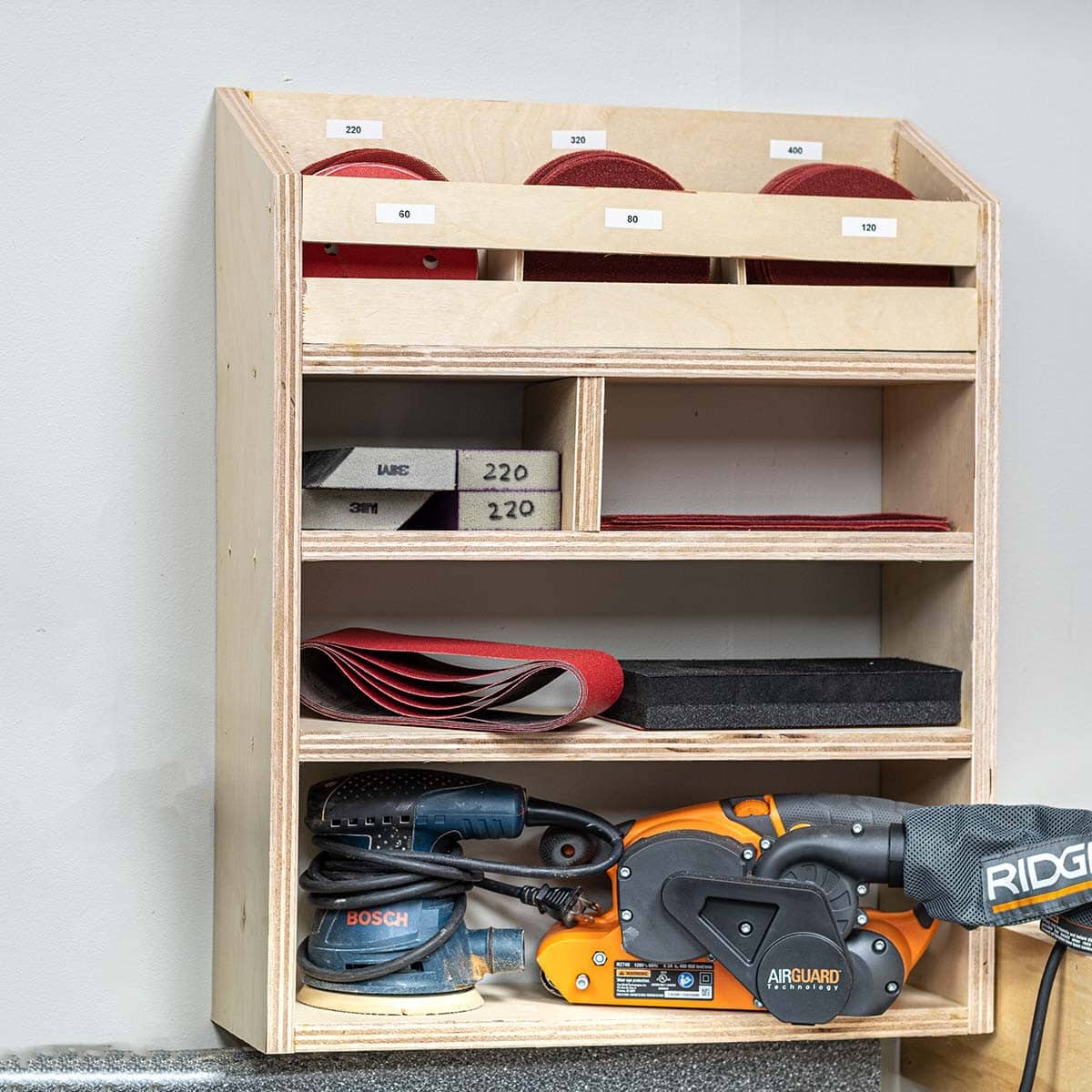 Sandpaper and sander storage on wall