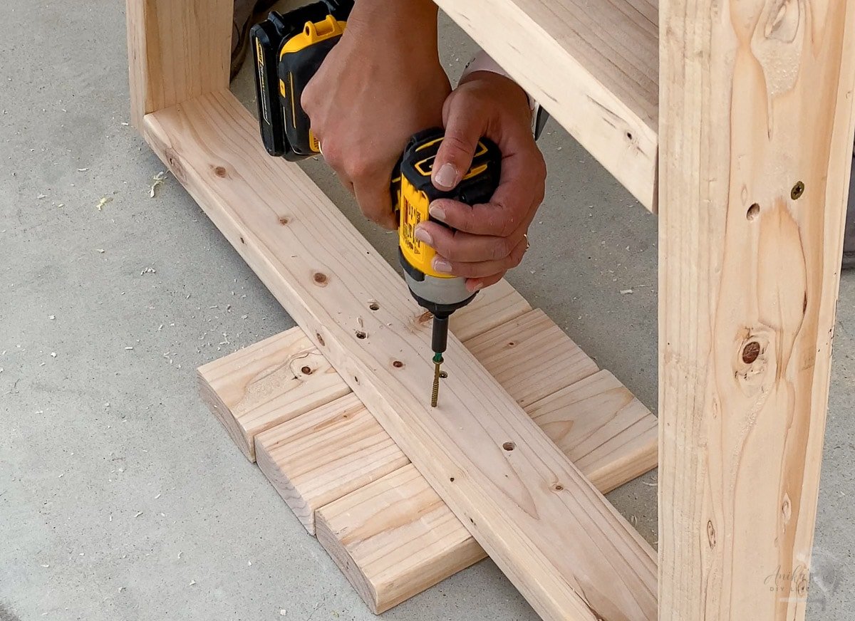 woman adding a screw into the support