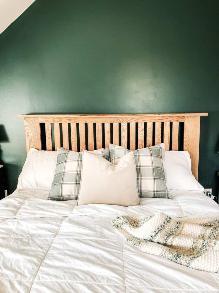 DIY wooden headboard against a green wall