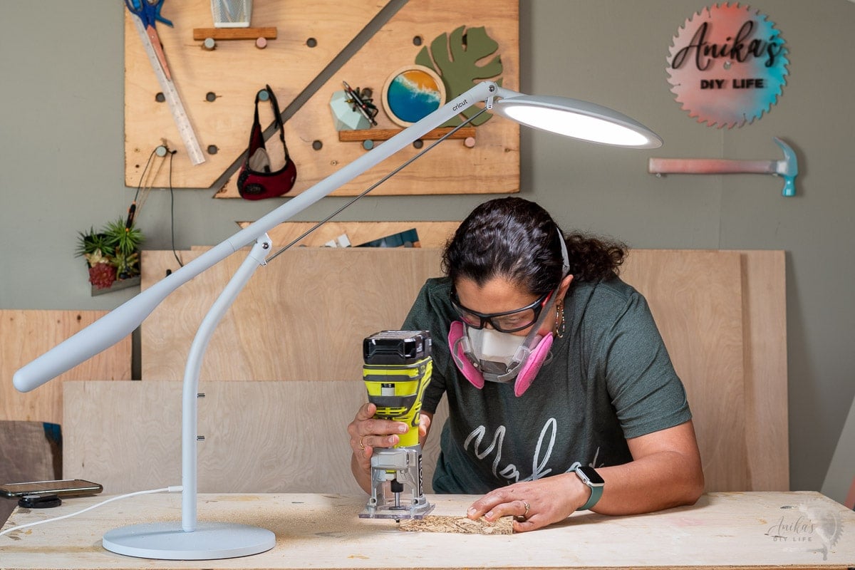 Woman using Cricut Bright 360 in workshop and routing