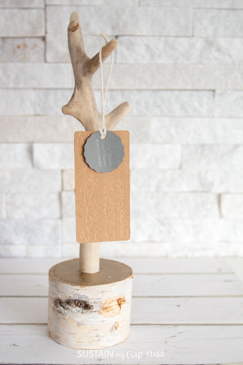 Wooden product tag hanging on a tree branch display