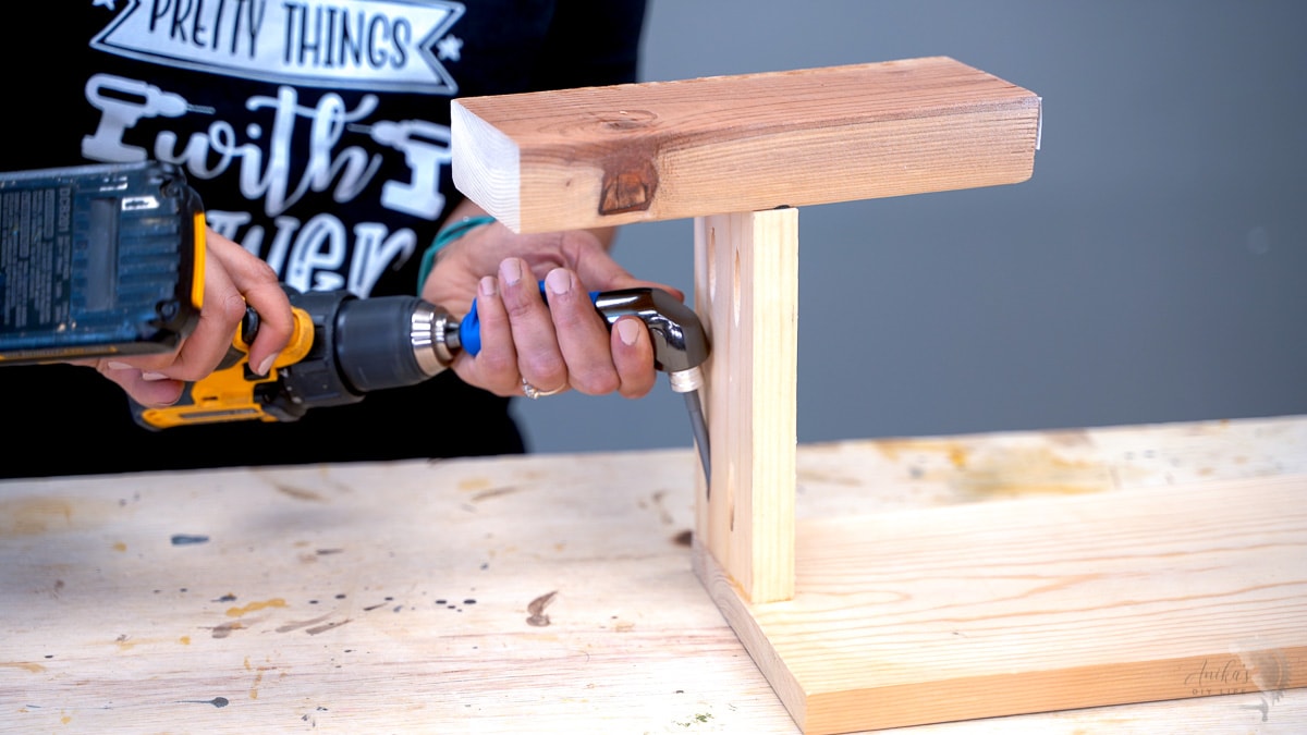 woman using the 90-degree pocket hole driver to add pocket hole screw in tight space