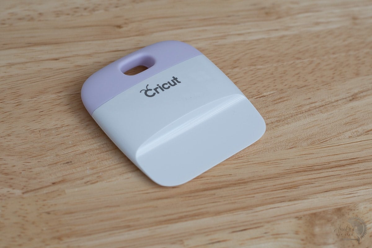 Cricut scraper on a wood desk