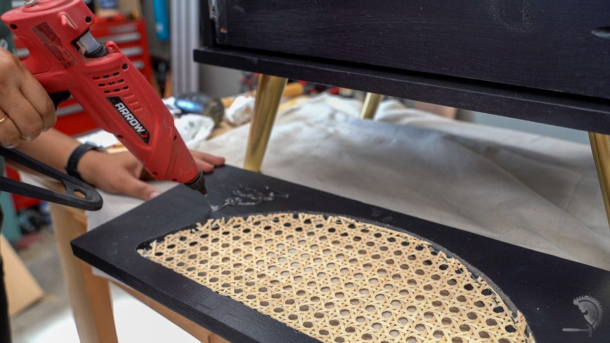 Using hot glue to attach the drawer front