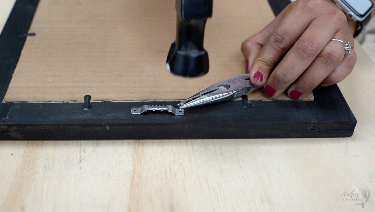 Adding sawtooth hangers to the diy picture frame