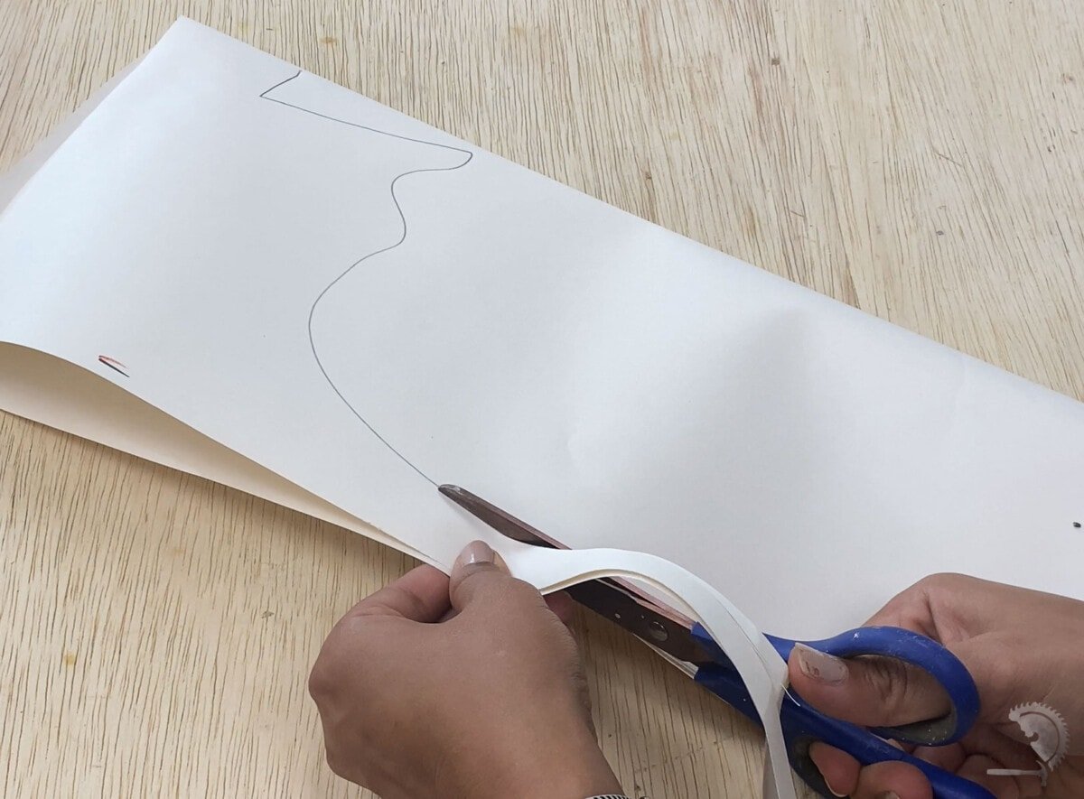 Cutting pumpkin template out of paper for plywood pumpkins