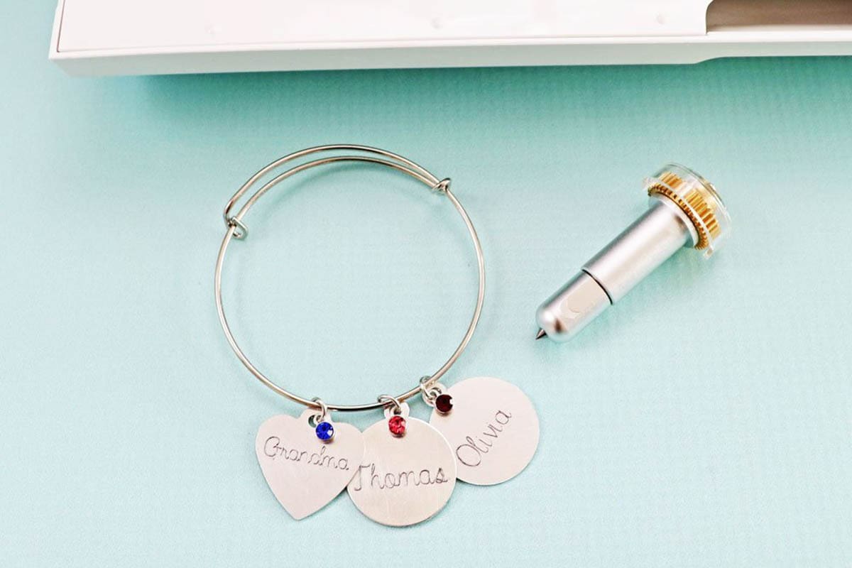 Charm bracelet pictured with the Cricut engraving too.