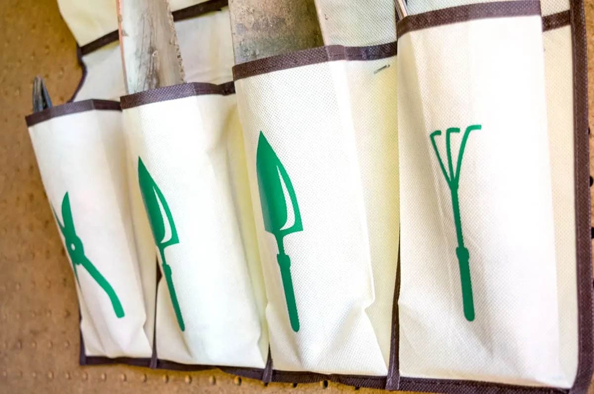 Garden tool organizer with tool graphics on pockets