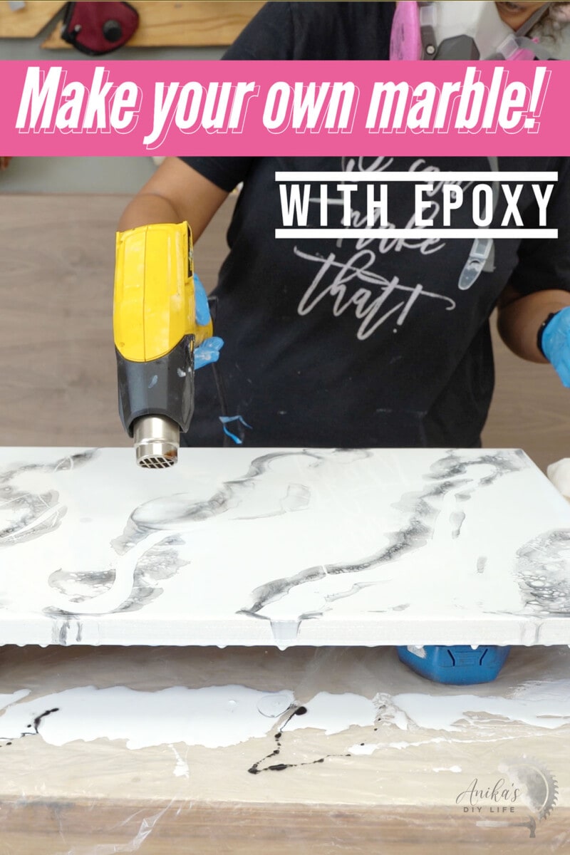 Woman creating marble look using heat gun to move and mix epoxy
