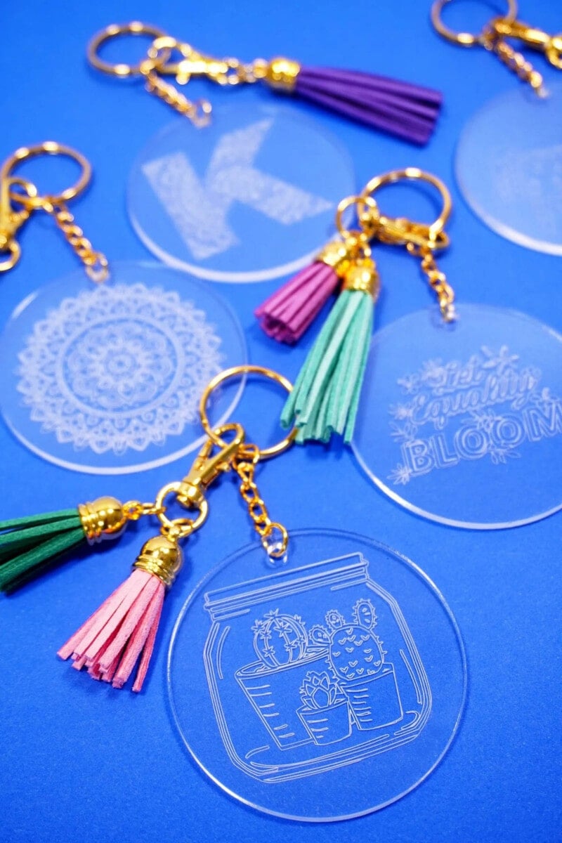 Round acrylic keychains engraved with designs using the Cricut engraving tip