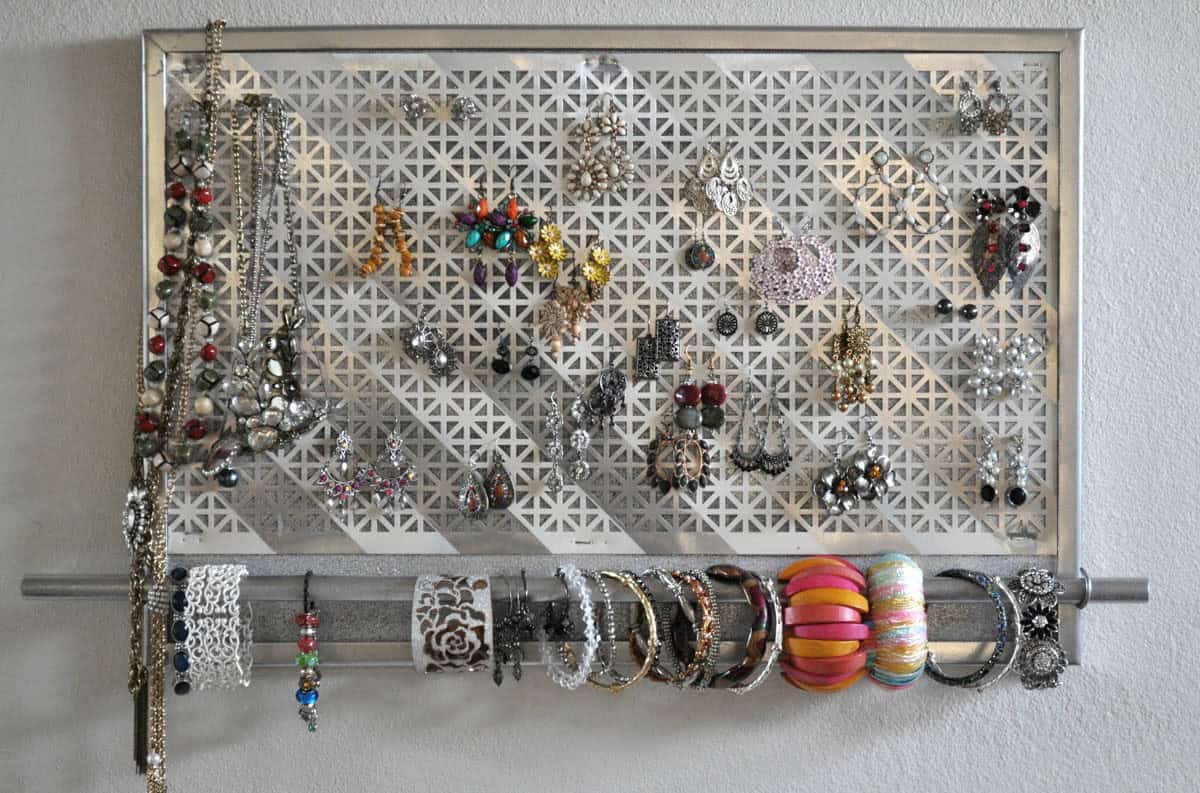 wall mounted jewelry organizer filled with jewelry