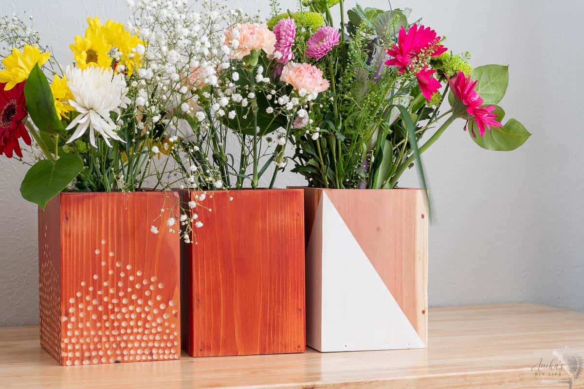 redwood vases on table with flowers