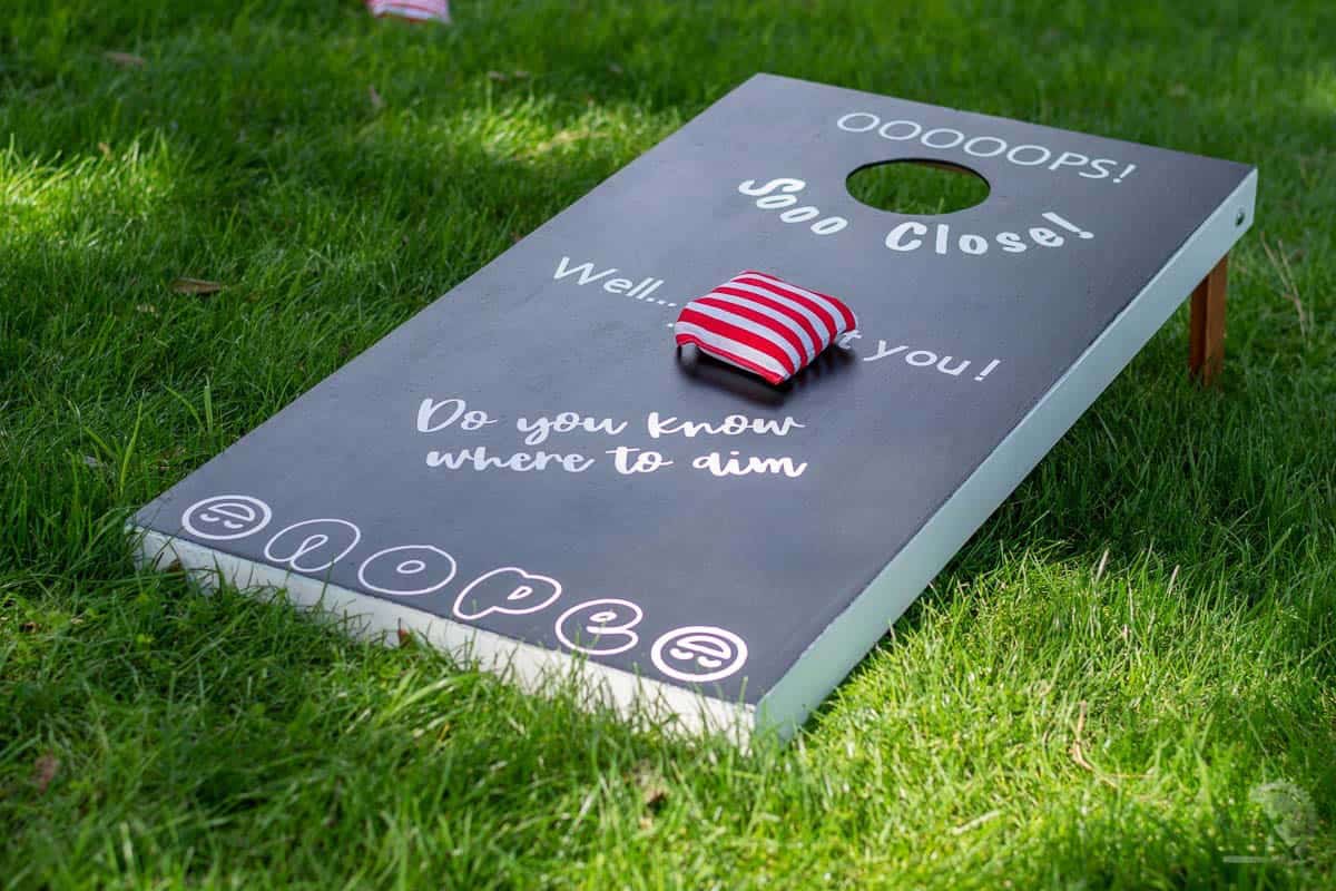 lightweight cornhole boards painted black with lettering