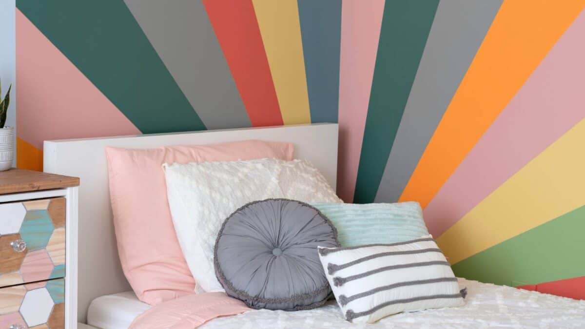 Colorful Sunburst painted in the corner of a bedroom 