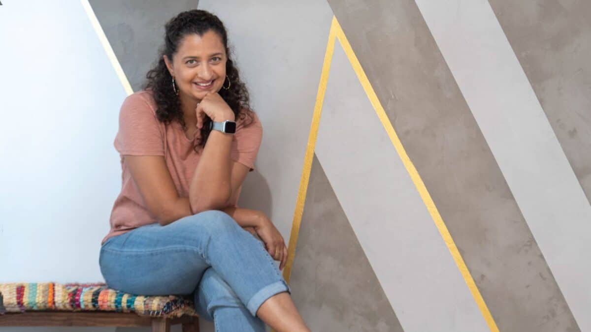 Anika sitting in front of DIY concrete accent wall