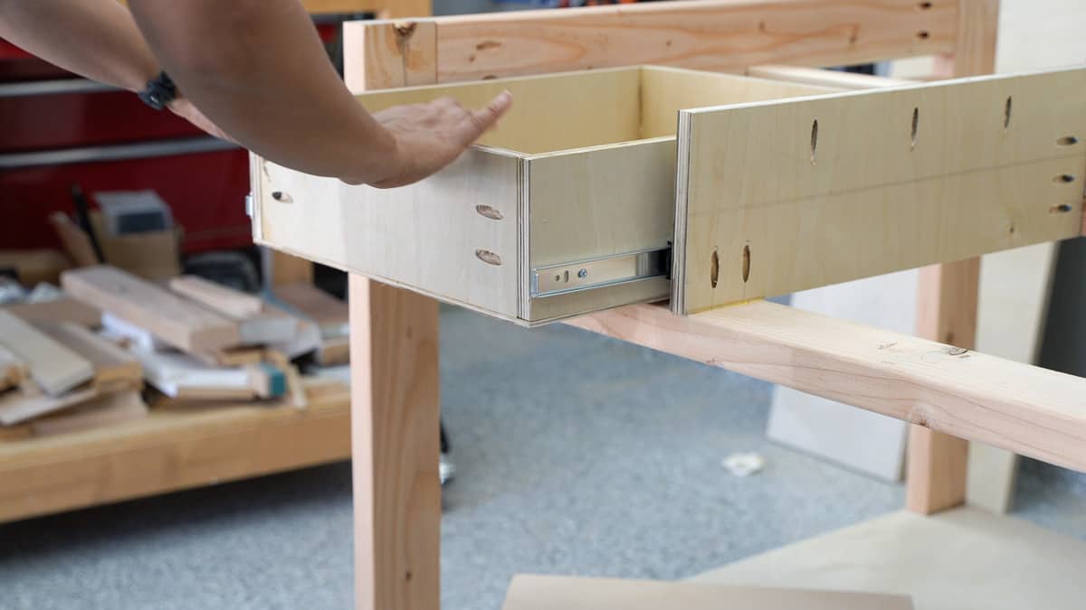 WOman attachig screw to the workbench