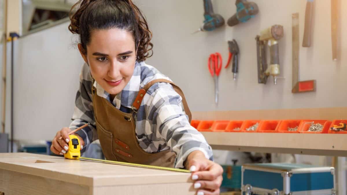 woman measuring woodworking project