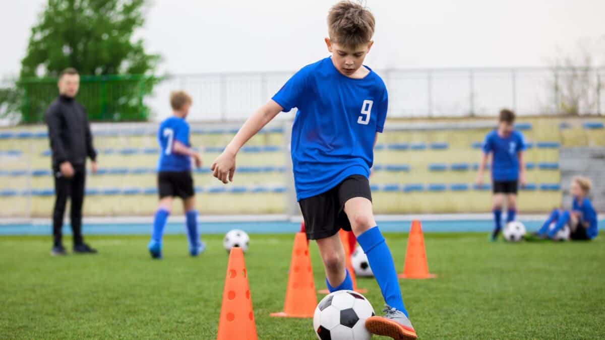 boy practicing soccer