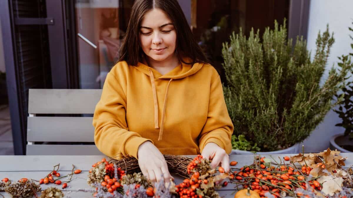 woman making a fall wreath