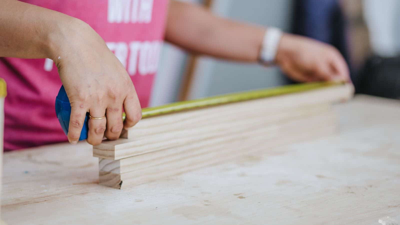 Anika measuring wood