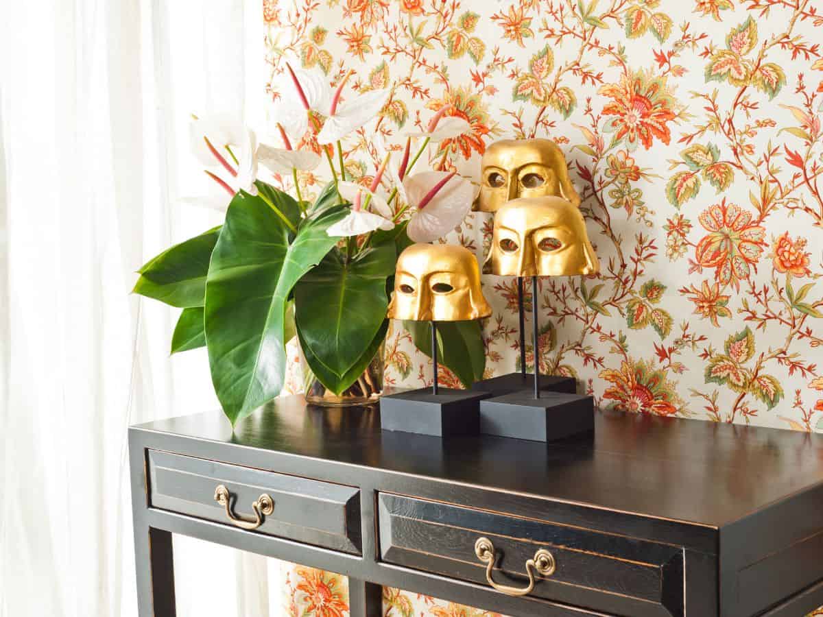 vintage floral wallpaper on wall behind console table