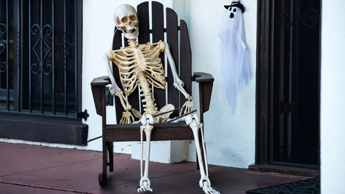 Skeleton sitting in a chair on a porch