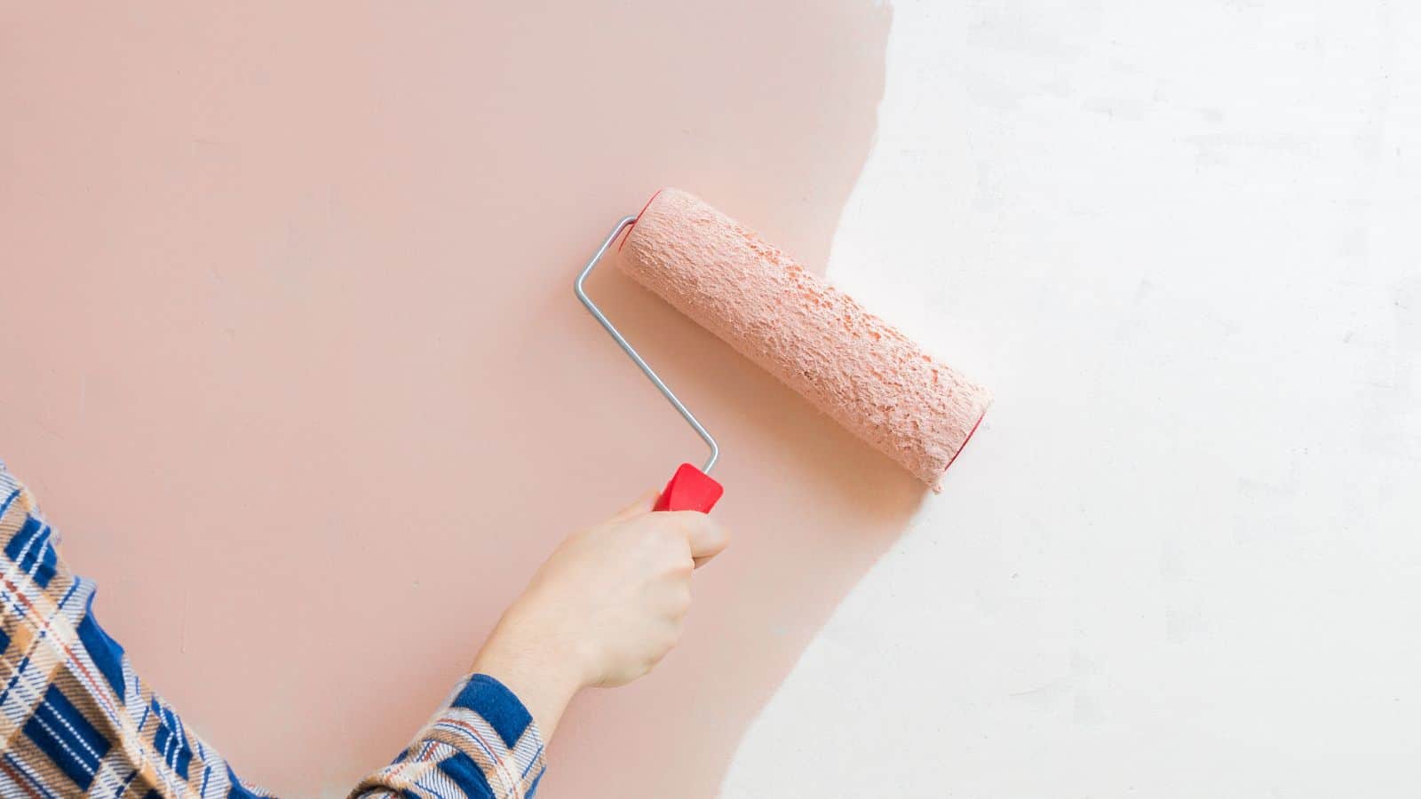 applying thin coats of paint to a wall