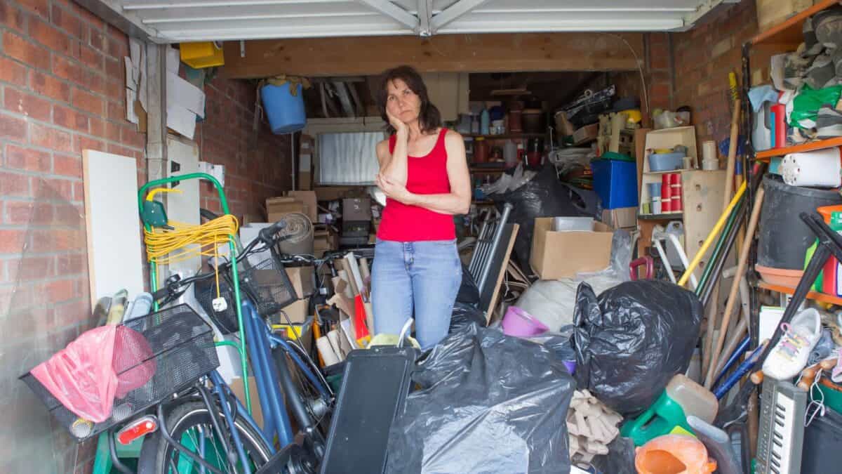 Woman standing in a messy garage