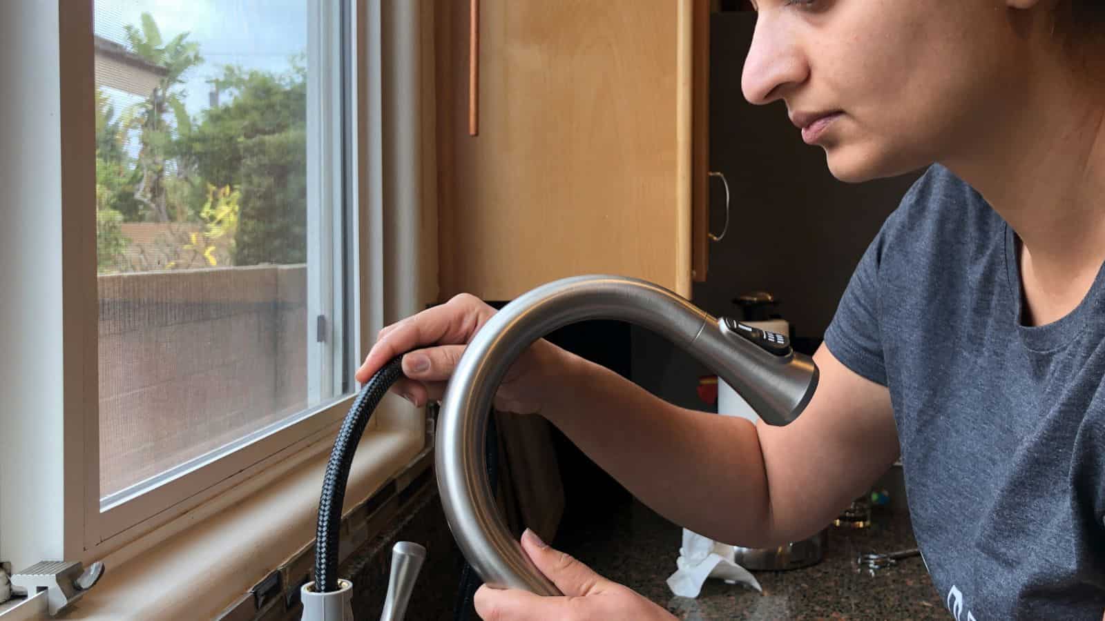 Anika changing a kitchen faucet