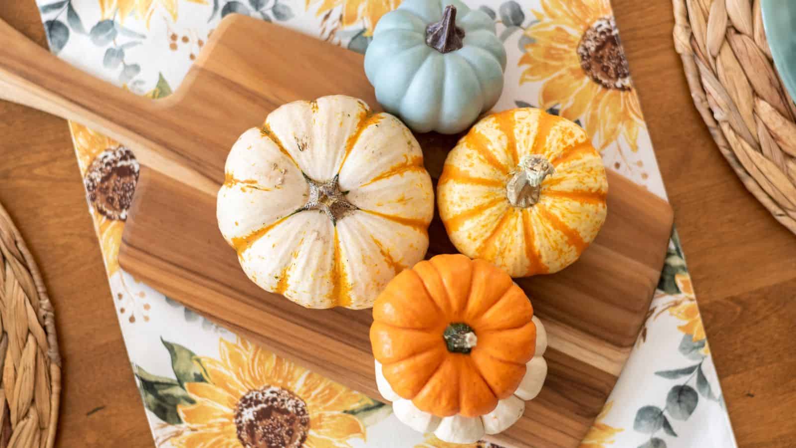 pumpkins on a cutting board on a table