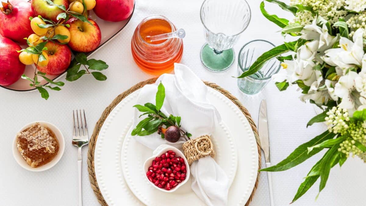 Table setting with apples and lemons in a bowl