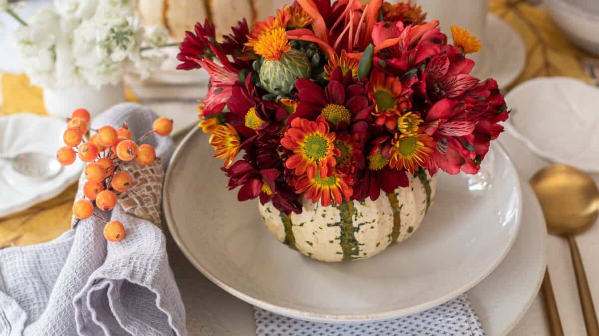 pumpkin used as a vase for mums