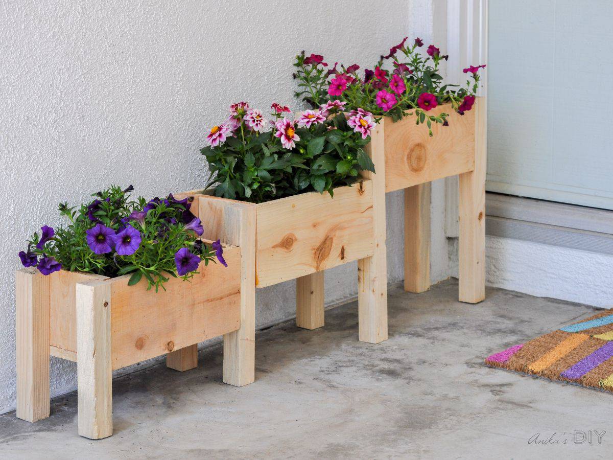 DIY tiered planter with flowers in it on a front porch