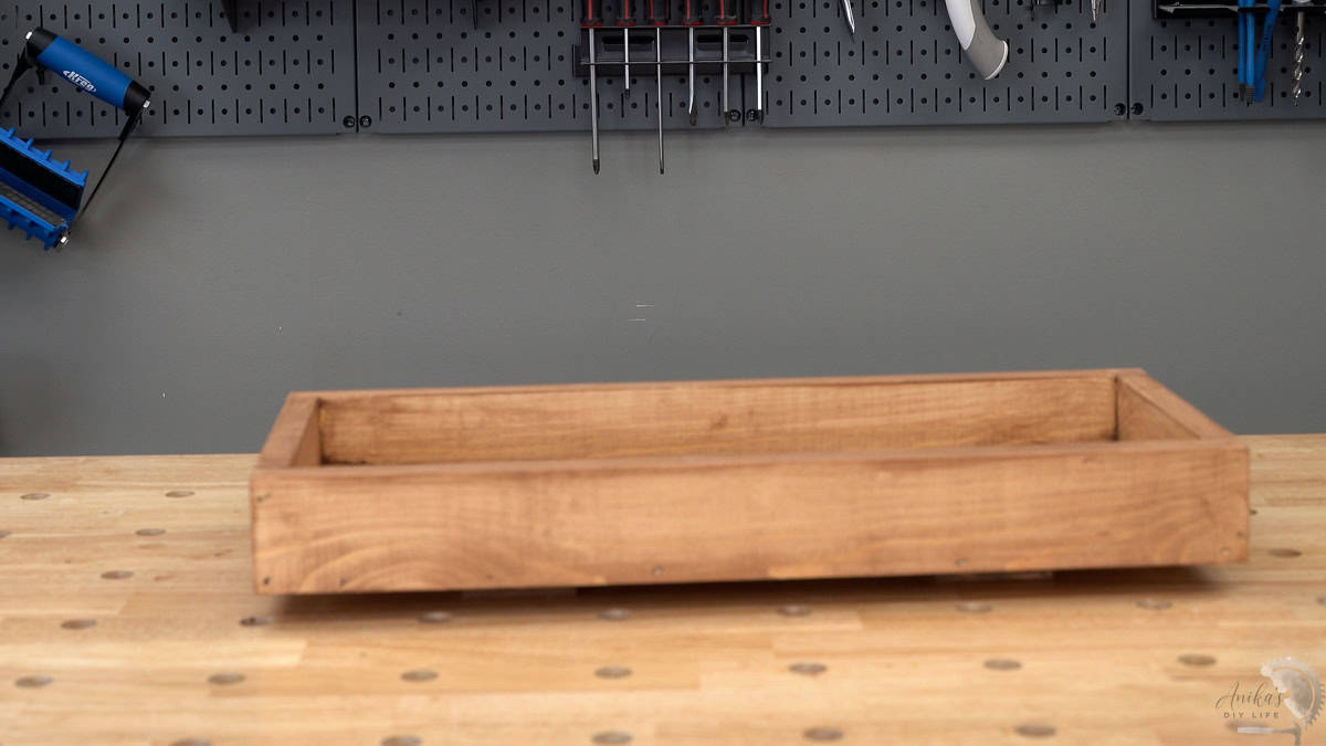Finished tray stained brown on the workbench