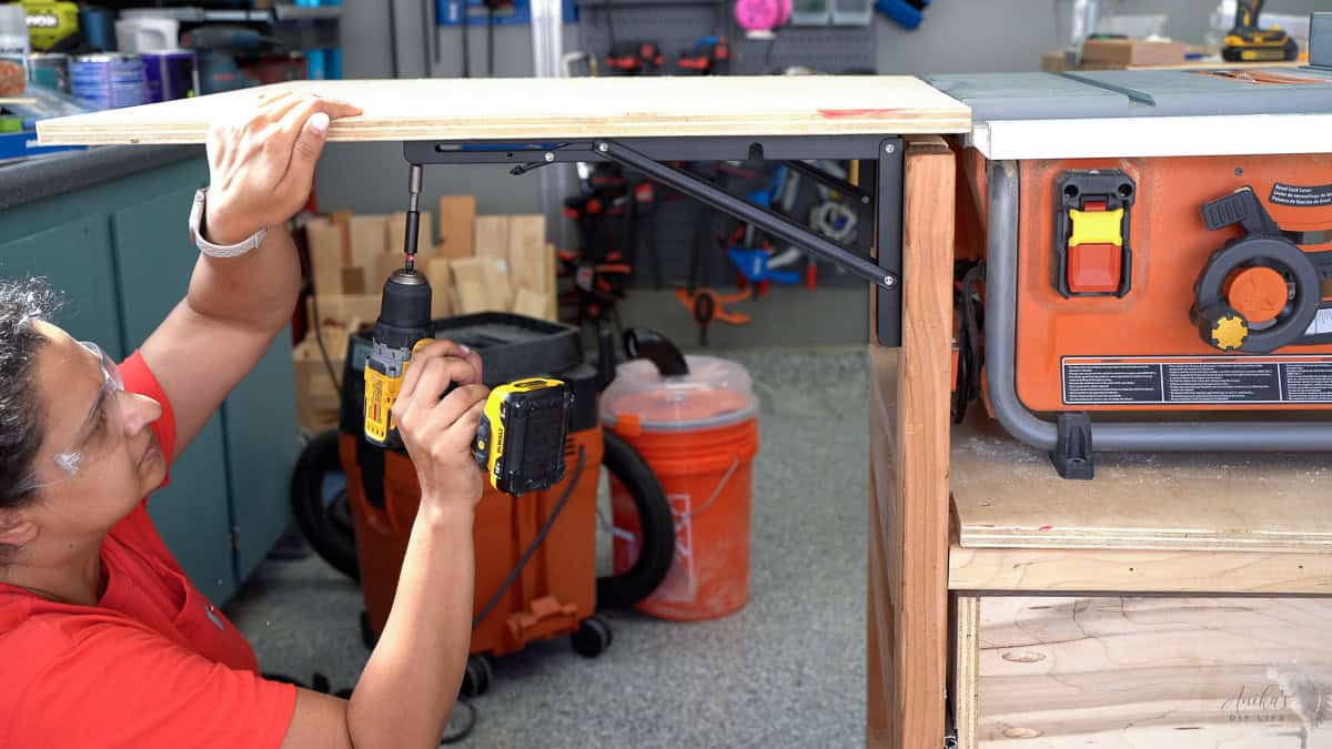 attaching the extension wing to the folding table brackets