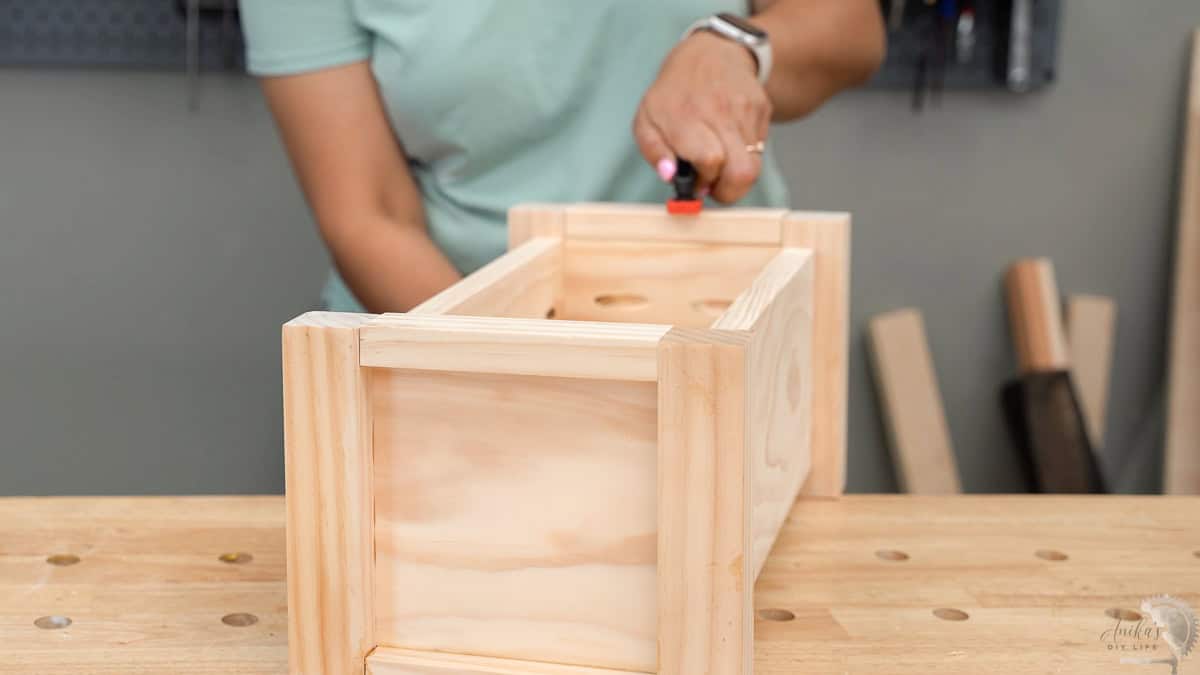Attaching the top trim on the planter and clamping it