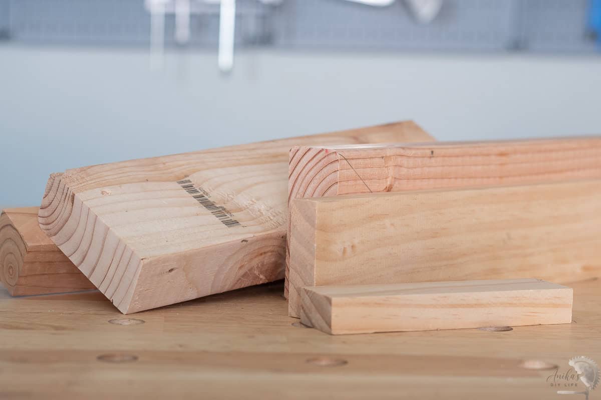 A bunch of pine and fir boards on the workbench in a workshop