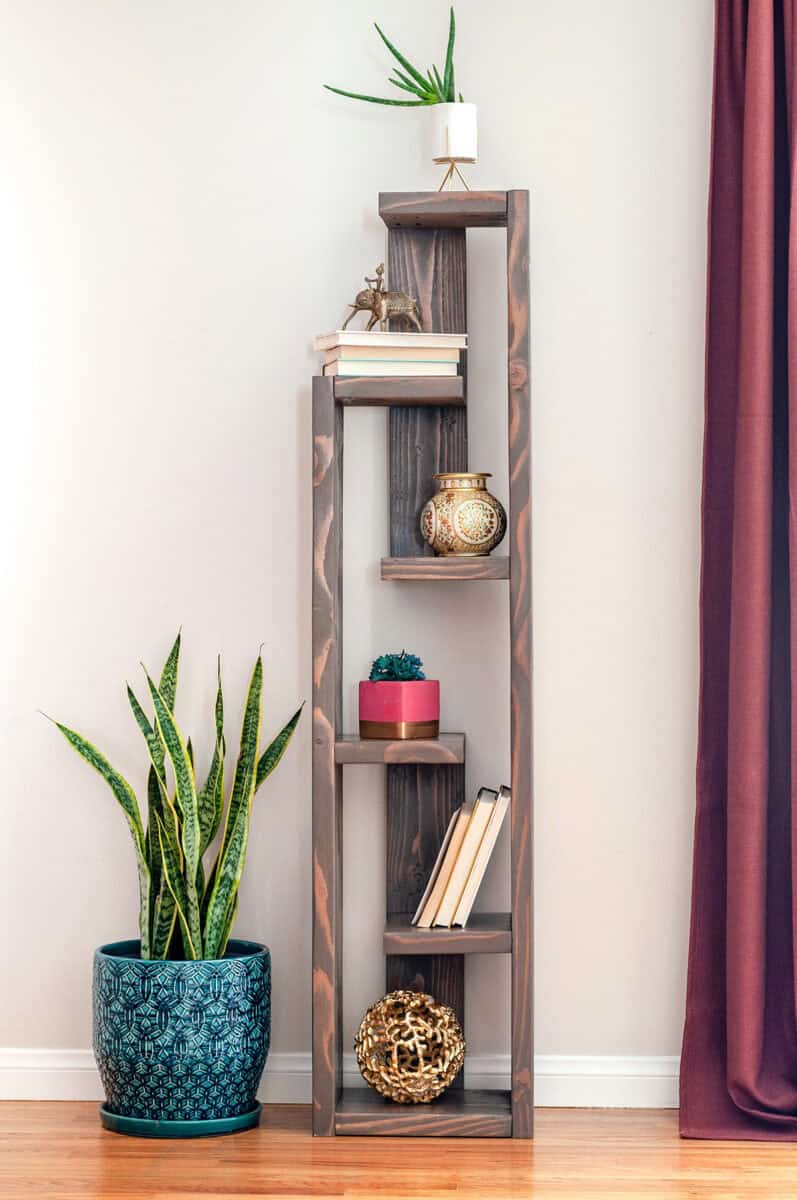 A modern DIY bookshelf with decoration around it.