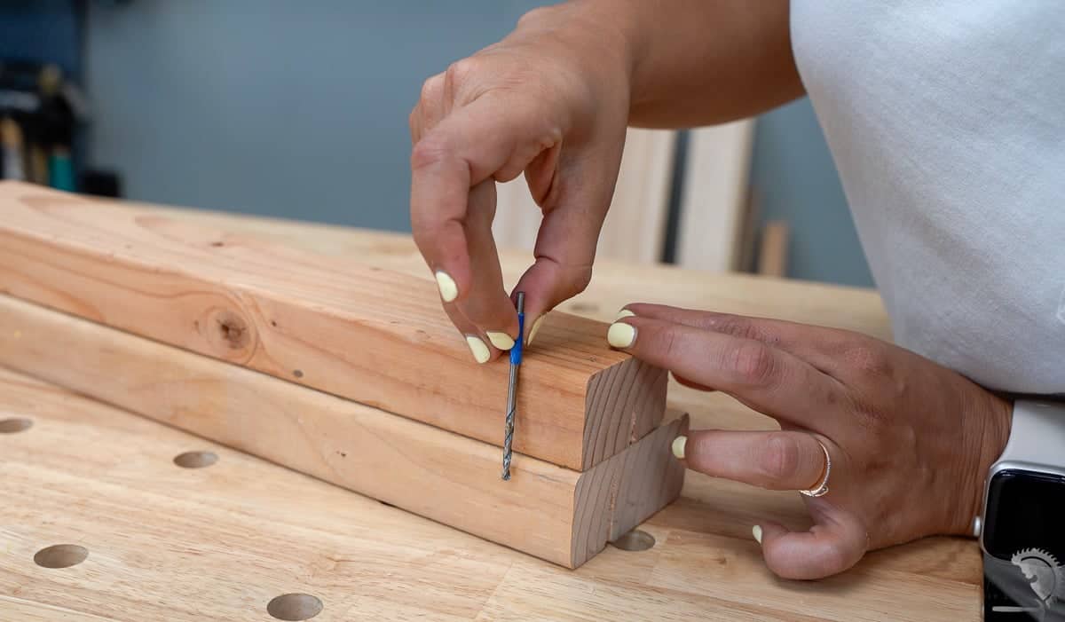 Marking the depth of the predrilled pilot hole in wood.
