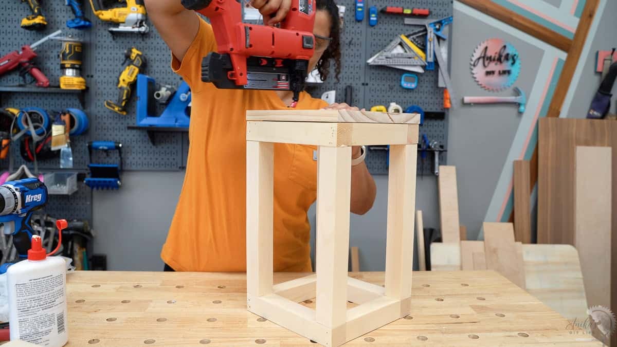 attaching the base of the house shaped lantern using wood glue and brad nails.